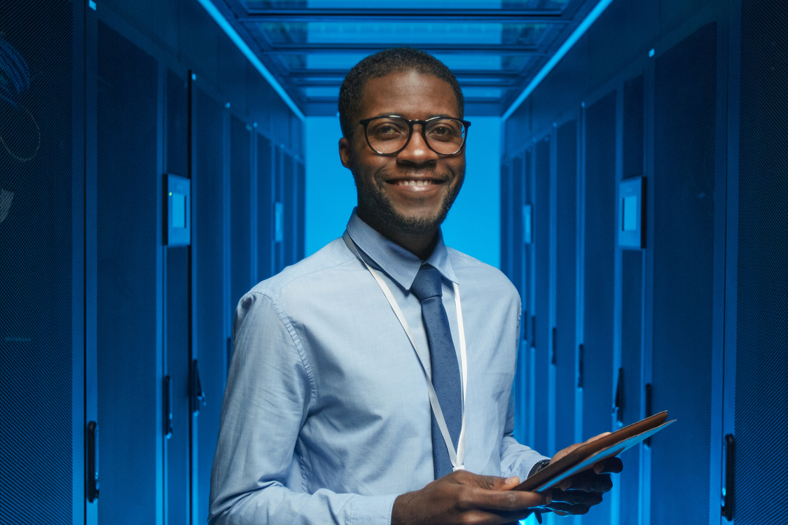 Image of a smiling man holding a tablet