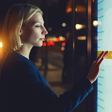 Image of a woman working on a large touch screen device