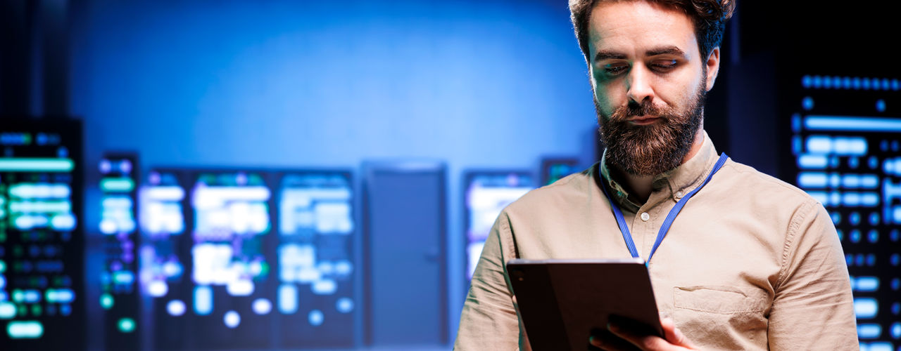 Image of a man looking into a computer tablet