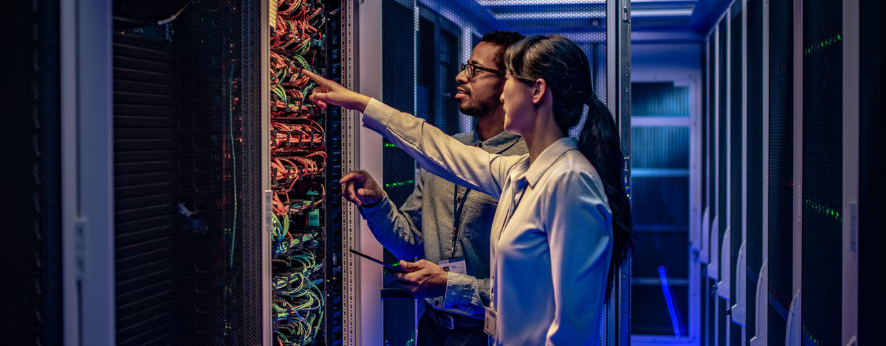 Image of people looking into a server room