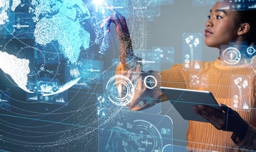 Image of a young lady holding a tablet device writing on a hologram