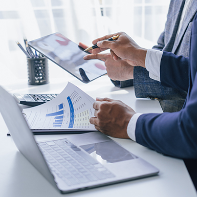 image of a laptop and paper with graphs